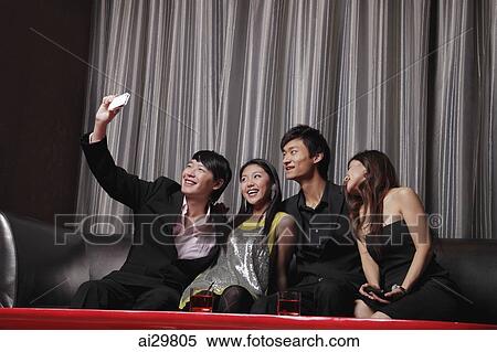 A group of friends take a photo of each other View Large Photo Image Stock Photography - A group of friends take a photo of each other. Fotosearch