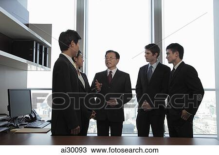 A small group of business people talking together View Large Photo Image Stock Image - A small group of business people talking together. Fotosearch
