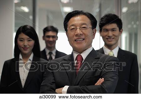 Businessman standing in front of colleagues View Large Photo Image Stock Photo - Businessman standing in front of colleagues. Fotosearch