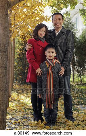 Family with young boy standing outdoors View Large Photo Image Stock Photo - Family with young boy standing outdoors. Fotosearch