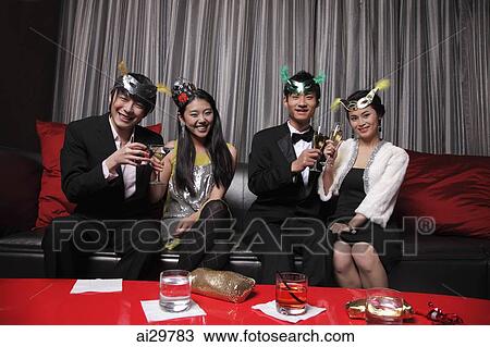 Four people celebrating at a party together View Large Photo Image Stock Image - Four people celebrating at a party together. Fotosearch