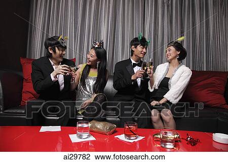 Four people dressed up at a party, toasting each other View Large Photo Image Stock Image - Four people dressed up at a party, toasting each other. Fotosearch