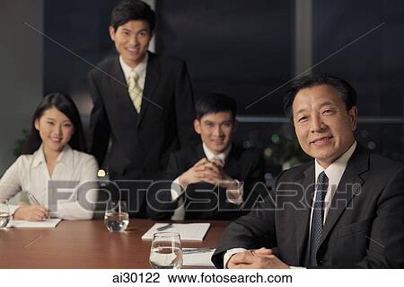 Four people having a business meeting View Large Photo Image Stock Image - Four people having a business meeting. Fotosearch