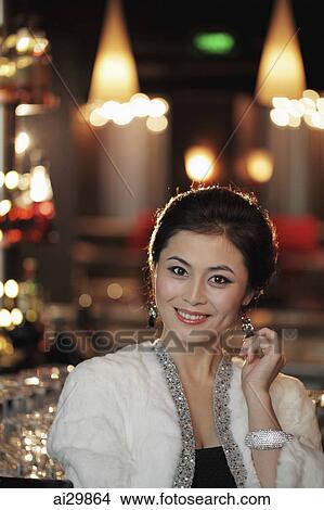 Head shot of elegantly dressed woman with diamond jewelry at night View Large Photo Image Picture - Head shot of elegantly dressed woman with diamond jewelry at night. Fotosearch