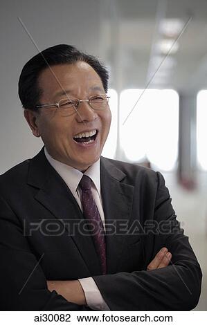 Head shot of mature man in business suit laughing View Large Photo Image Stock Image - Head shot of mature man in business suit laughing. Fotosearch