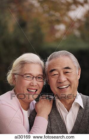 Stock Photo - Head shot of older couple smiling together. Fotosearch