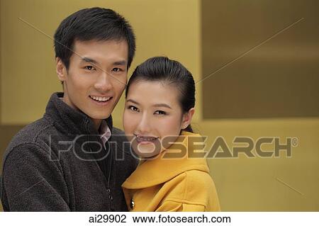 Head shot of smiling young couple hugging View Large Photo Image Stock Image - Head shot of smiling young couple hugging. Fotosearch