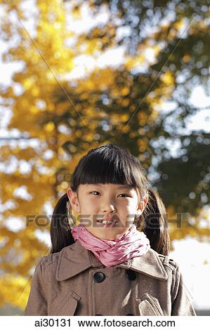 Head shot of young girl in coat outdoors View Large Photo Image Stock Image - Head shot of young girl in coat outdoors. Fotosearch