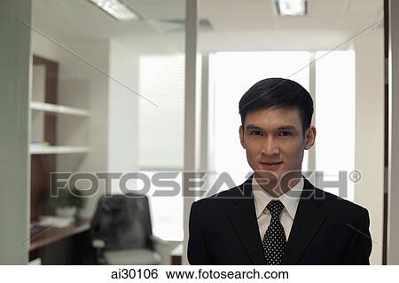 Head shot of young man in his office View Large Photo Image Stock Photograph - Head shot of young man in his office. Fotosearch