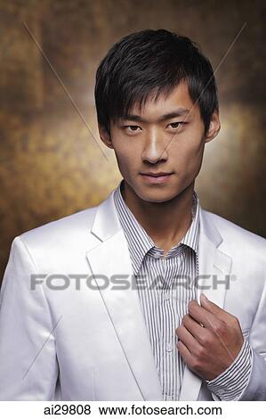 Stock Photo - Head shot of young man in white coat. Fotosearch