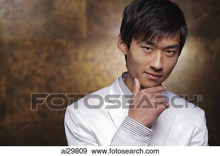 Head shot of young man in white coat View Large Photo Image Stock Photo - Head shot of young man in white coat. Fotosearch