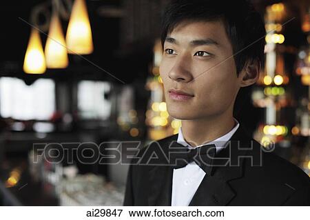 Stock Photo - Head shot of young man wearing a tuxedo. Fotosearch