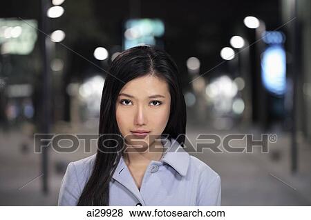 Head shot of young woman on the street at night View Large Photo Image Stock Photo - Head shot of young woman on the street at night. Fotosearch