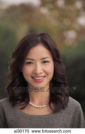 Head shot of young woman wearing pearls and smiling View Large Photo Image Stock Image - Head shot of young woman wearing pearls and smiling. Fotosearch