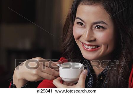 Head shot young woman holding cup View Large Photo Image Stock Image - Head shot young woman holding cup. Fotosearch