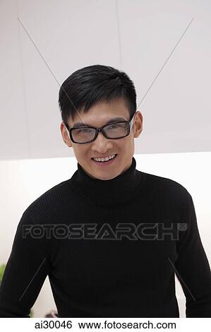 Headshot of young man wearing glasses and smiling View Large Photo Image Stock Photograph - Headshot of young man wearing glasses and smiling. Fotosearch