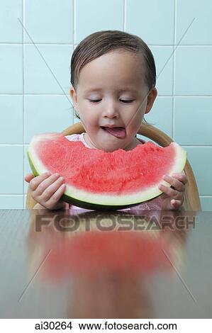 Little girl eating watermelon and licking her lips View Large Photo Image Picture - Little girl eating watermelon and licking her lips. Fotosearch