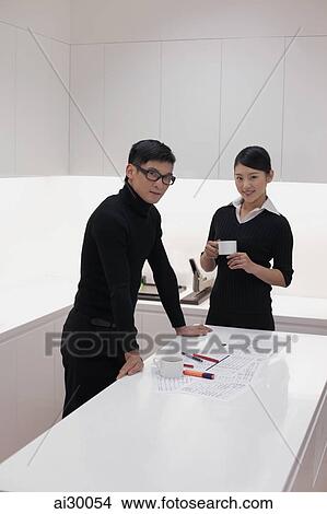 Man and woman dressed in black working in modern office View Large Photo Image Picture - Man and woman dressed in black working in modern office. Fotosearch