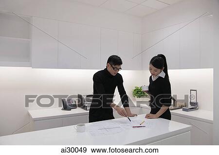 Man and woman working together in a modern office View Large Photo Image Stock Photo - Man and woman working together in a modern office. Fotosearch
