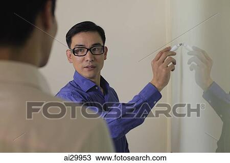 Man explaining something while writing on white board View Large Photo Image Stock Image - Man explaining something while writing on white board. Fotosearch