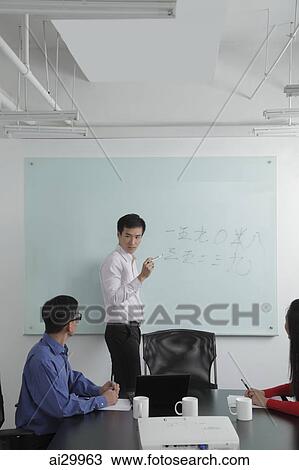 Man giving a presentation during a meeting View Large Photo Image Stock Image - Man giving a presentation during a meeting. Fotosearch