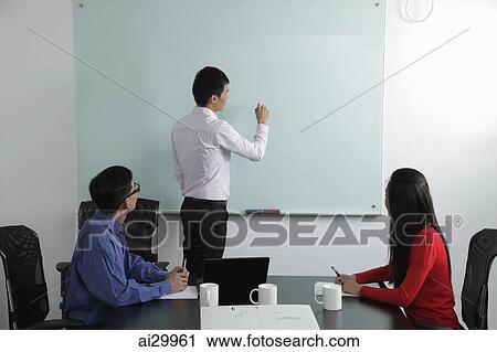 Man writing on white board during a meeting View Large Photo Image Stock Image - Man writing on white board during a meeting. Fotosearch
