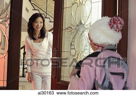 Mother answering the door for her daughter dressed in hat and coat View Large Photo Image Stock Image - Mother answering the door for her daughter dressed in hat and coat. Fotosearch