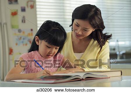 Mother helping her daughter with her homework View Large Photo Image Stock Photograph - Mother helping her daughter with her homework. Fotosearch