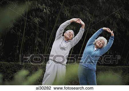 Older man and woman stretching together outdoors View Large Photo Image Stock Image - Older man and woman stretching together outdoors. Fotosearch
