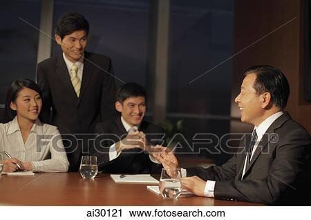 People smiling during a business meeting View Large Photo Image Stock Image - People smiling during a business meeting. Fotosearch