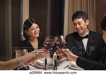 People toasting during a dinner party View Large Photo Image Picture - People toasting during a dinner party. Fotosearch