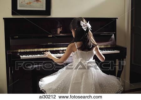 Rear view of young girl playing piano in white dress View Large Photo Image Stock Image - Rear view of young girl playing piano in white dress. Fotosearch