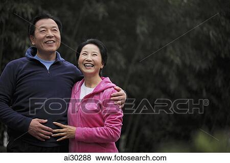 Senior couple embracing and laughing View Large Photo Image Stock Photo - Senior couple embracing and laughing. Fotosearch