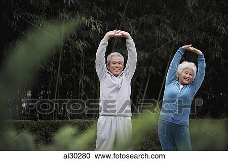 Senior man and woman stretching together outdoors View Large Photo Image Stock Image - Senior man and woman stretching together outdoors. Fotosearch