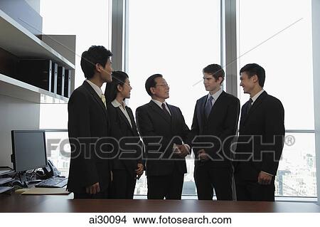 Small group of business people talking together View Large Photo Image Picture - Small group of business people talking together. Fotosearch