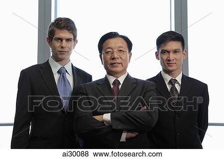 Three businessmen standing together View Large Photo Image Stock Photo - Three businessmen standing together. Fotosearch