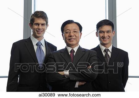 Three businessmen standing together View Large Photo Image Stock Photo - Three businessmen standing together. Fotosearch