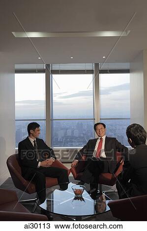 Three businessmen talking in an office View Large Photo Image Stock Image - Three businessmen talking in an office. Fotosearch