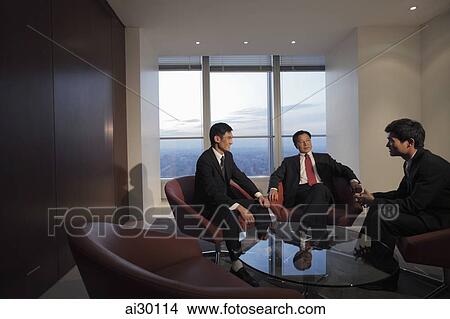 Three businessmen talking in office View Large Photo Image Picture - Three businessmen talking in office. Fotosearch