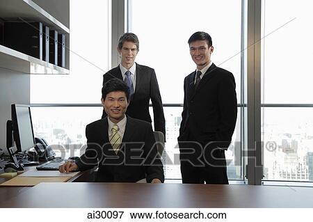 Three businessmen working together in an office View Large Photo Image Stock Photo - Three businessmen working together in an office. Fotosearch