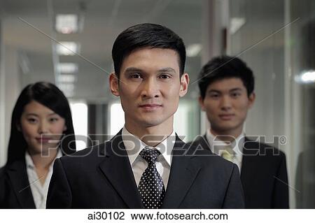 Three businesspeople standing in hallway View Large Photo Image Stock Image - Three businesspeople standing in hallway. Fotosearch