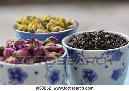 Stock Image - Three cups of dried flowers for tea. Fotosearch