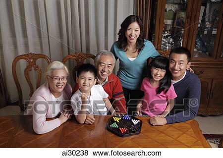 Three generation family playing games together View Large Photo Image Stock Photo - Three generation family playing games together. Fotosearch