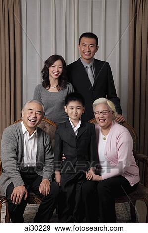 Three generational family posing for a photo together View Large Photo Image Stock Photo - Three generational family posing for a photo together. Fotosearch