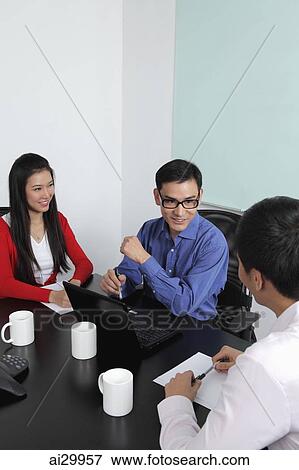Three people having a meeting View Large Photo Image Stock Photo - Three people having a meeting. Fotosearch