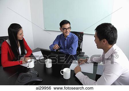 Three people having a meeting View Large Photo Image Stock Photograph - Three people having a meeting. Fotosearch