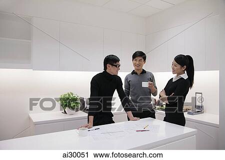Three people talking in modern office View Large Photo Image Stock Image - Three people talking in modern office. Fotosearch