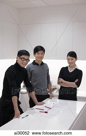 Three people working together in modern office View Large Photo Image Stock Image - Three people working together in modern office. Fotosearch
