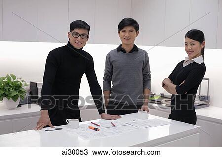 Three people working together in modern office building View Large Photo Image Stock Image - Three people working together in modern office building. Fotosearch