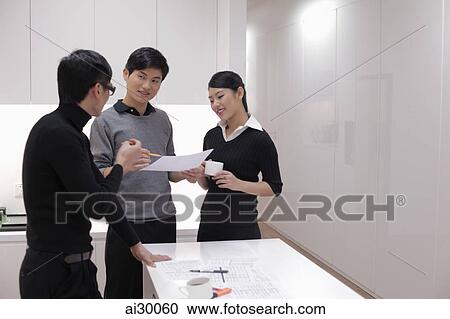 Three people working together in modern office View Large Photo Image Stock Image - Three people working together in modern office. Fotosearch